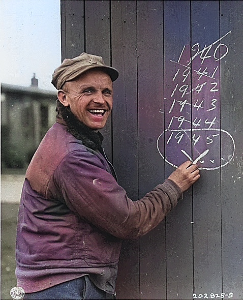 British Sergeant Edward Hill, captured by the Germans at Dunkerque, France in 1940, smiling as he was librated in late Mar 1945 [Colorized by WW2DB]