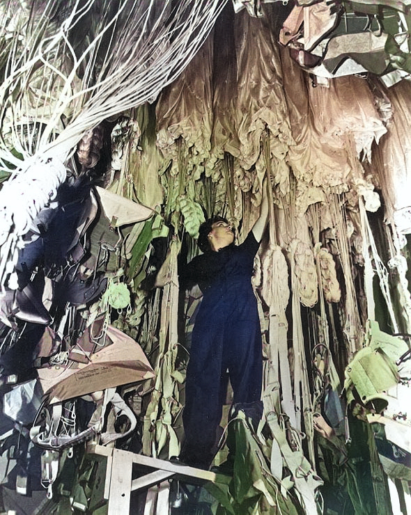 WAVES Parachute Rigger working in a Naval Air Station's parachute loft, date unknown [Colorized by WW2DB]