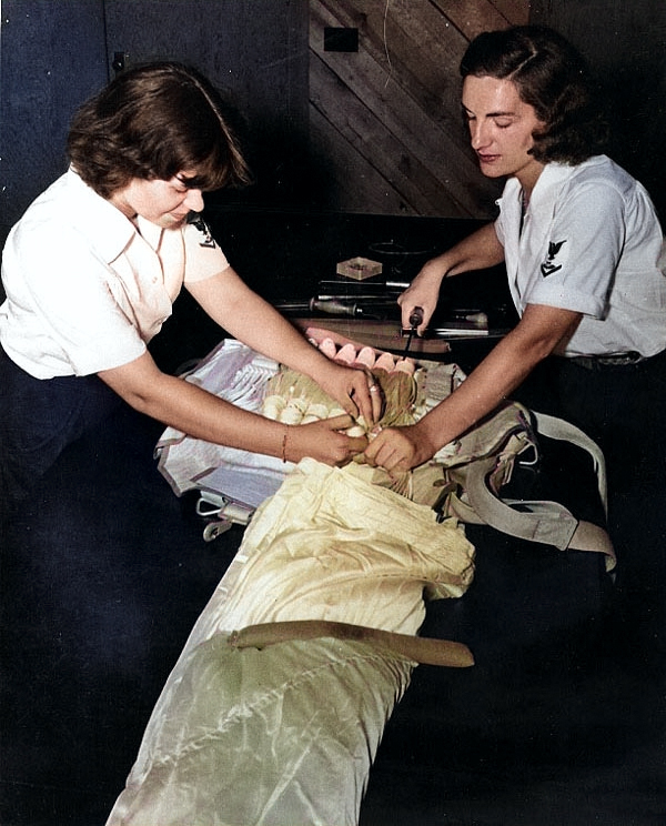 WAVES Parachute Riggers 3rd Class Pearl L. Pittelkow and Virginia Sibbald repacking a parachute, Naval Air Station, Memphis, Tennessee, United States, circa 1943, photo 1 of 2 [Colorized by WW2DB]