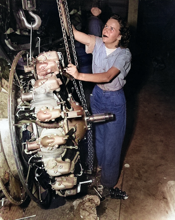 WAVES Aviation Machinist's Mate Elizabeth Abercrombie using a chain fall to lift a radial aircraft engine, at a Naval Air Station in the United States, date unknown [Colorized by WW2DB]