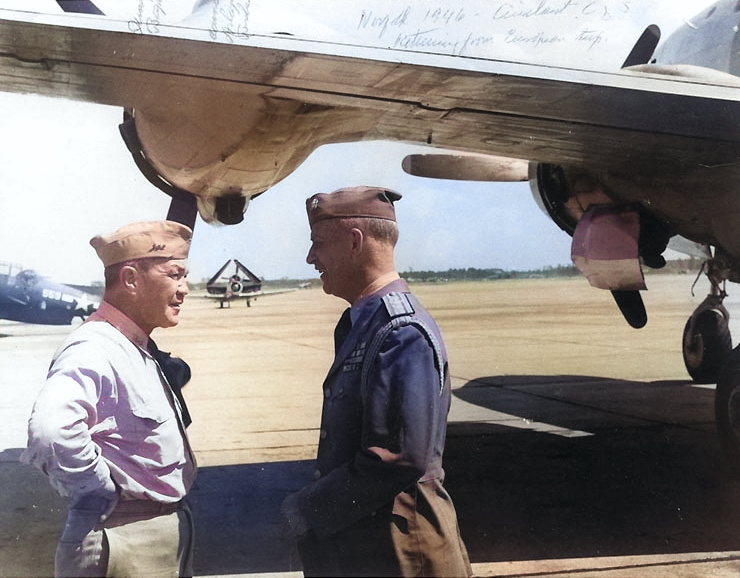 RAdm Gerald Bogan and Commodore A. Burke, Naval Air Station Norfolk, Virginia, United States, summer 1946; note wing of R5D Skymaster aircraft and TBF Avenger, SNJ, and SB2C Helldiver in background [Colorized by WW2DB]
