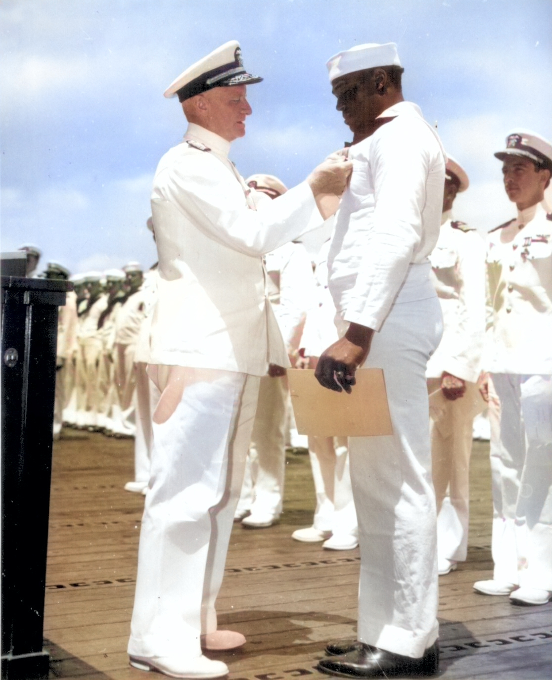 Doris Miller receiving the Navy Cross award from Admiral Chester Nimitz, onboard carrier Enterprise, Pearl Harbor, US Territory of Hawaii, 27 May 1942; photo 2 of 2 [Colorized by WW2DB]