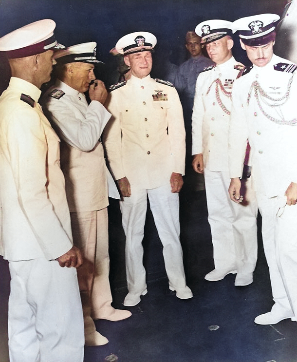 Admiral Mitscher and Commodore Burke aboard USS Franklin D. Roosevelt, 7 May 1946; other officers were Captain Thomas Regan, Vice Admiral Bernhard Bieri, and Lieutenant Commander Remington [Colorized by WW2DB]