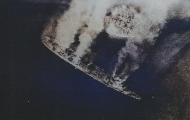 Repair ship Akashi burning as the result of US carrier aircraft attack, Palau Islands, 30 Mar 1944 [Colorized by WW2DB]