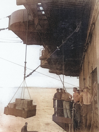 Loading stores on No. 5 sponson aboard USS Coral Sea, 6 May 1944 [Colorized by WW2DB]