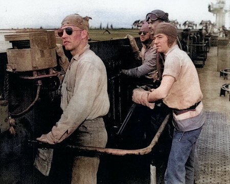 Bob Christensen, Jim Bough, L. D. Smith, and Frank Schwartz manning the arresting gear controls aboard USS Anzio, 20 Apr 1945 [Colorized by WW2DB]