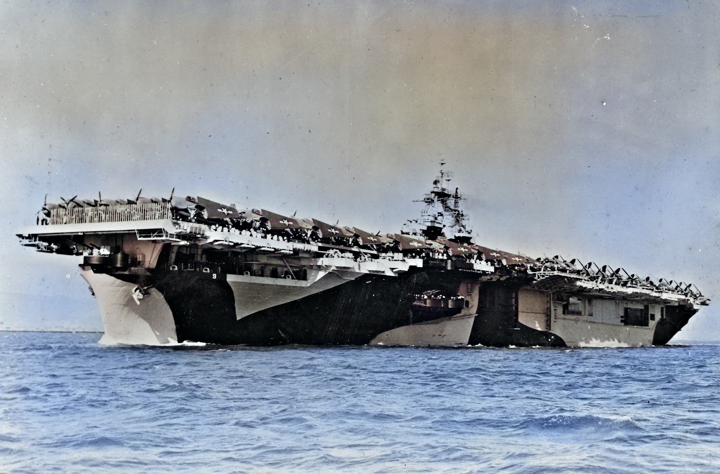 USS Essex departing San Francisco Naval Shipyard, California, United States, 15 Apr 1944, photo 2 of 4; note camouflage measure 32 design 6/10D [Colorized by WW2DB]
