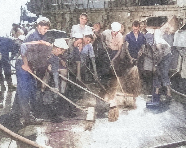 US Navy sailors scrubbing down the deck of USS IX-300 (former German cruiser Prinz Eugen) after the Baker atomic detonation of Operation Crossroads, Bikini Atoll, some days after 25 Jul 1946 [Colorized by WW2DB]