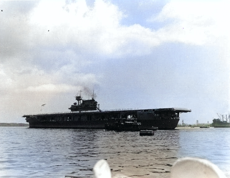 Yorktown arrived at Pearl Harbor after the Battle of Coral Sea, 27 May 1942, with her crew paraded in whites on the flight deck [Colorized by WW2DB]