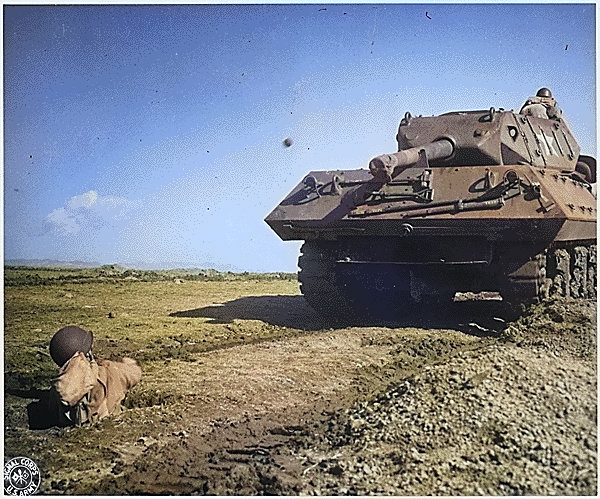 An US Army soldier practicing throwing a grenade from a foxhole toward a M10 tank destroyer, Camp Carson, Colorado, United States, 24 Apr 1943 [Colorized by WW2DB]