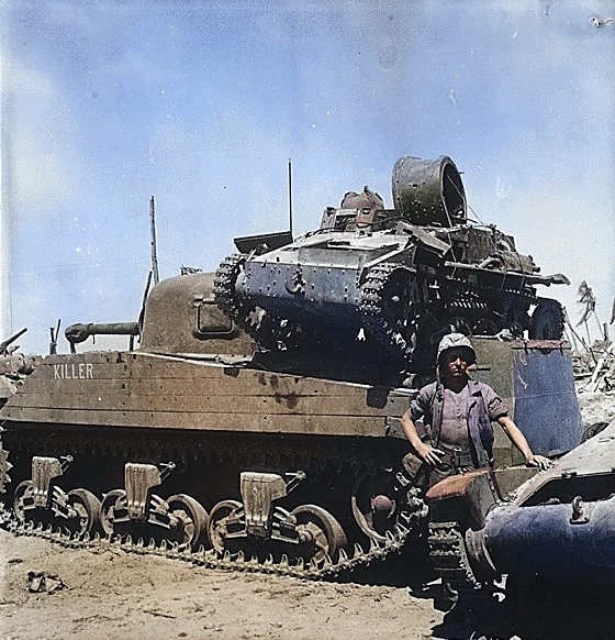 US Marine Private First Class N. E. Carling posing beside M4 Sherman tank 'Killer', which was carrying a knocked-out Japanese Type 94 Te Ke tankette, Kwajalein, Marshall Islands, 2 Feb 1944 [Colorized by WW2DB]