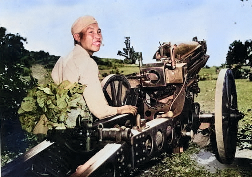 A Chinese soldier posing next to a M1A1 75-mm Pack Howitzer atop M1 carriage, circa 1942 [Colorized by WW2DB]