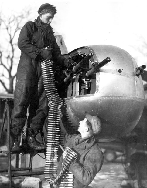 Two crew members loading ammunition for their A-26 bomber's M2 Browning machine guns, date unknown