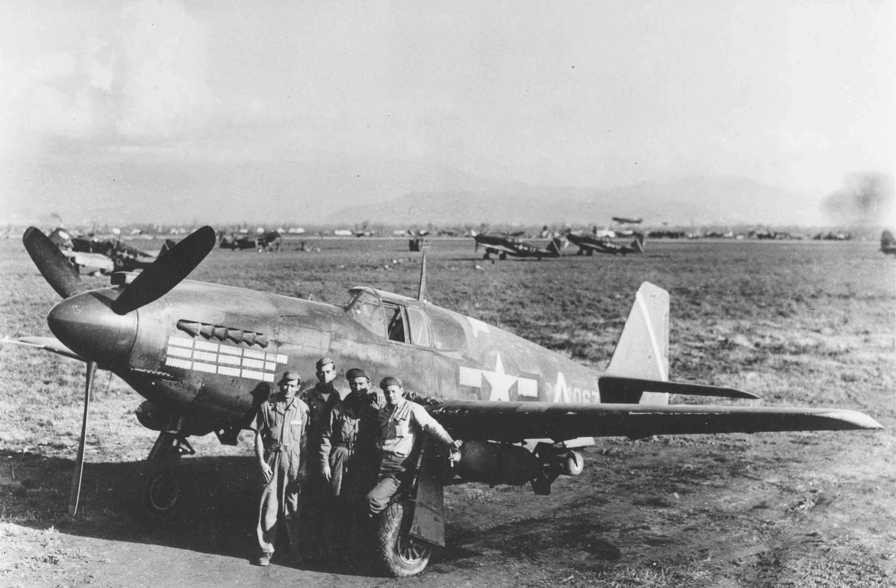 A-36A Mustang aircraft 42-84067 of the 527th FBS, 86th BFG, Gaudo Airfield, southern Italy, 14 Jan 1944; note chin-mounted guns and the bombing mission markings on the cowl