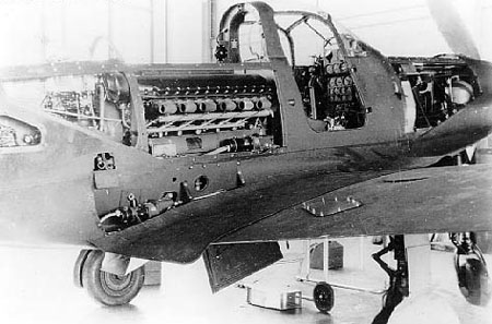 P-39 Airacobra aircraft with maintenance panels open, revealing the engine and other internal workings, date unknown