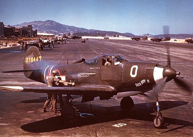 Ground crew starting 357th Fighter Group commander Col. Edward S. Chickering's P-39Q the hard way - with the hand crank to get the inertia starter going. Hamilton Field, California, United States, July 1943