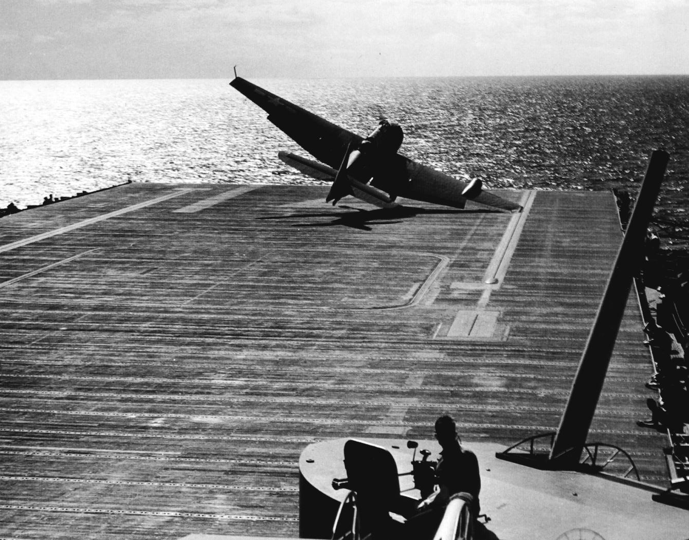 US Navy pilot Lt (jg) C. Clifton Francom unsuccessfully testing TBM Avenger torpedo bomber with experimental wing mounted radome aboard Ticonderoga, 4 Jul 1944, photo 1 of 5