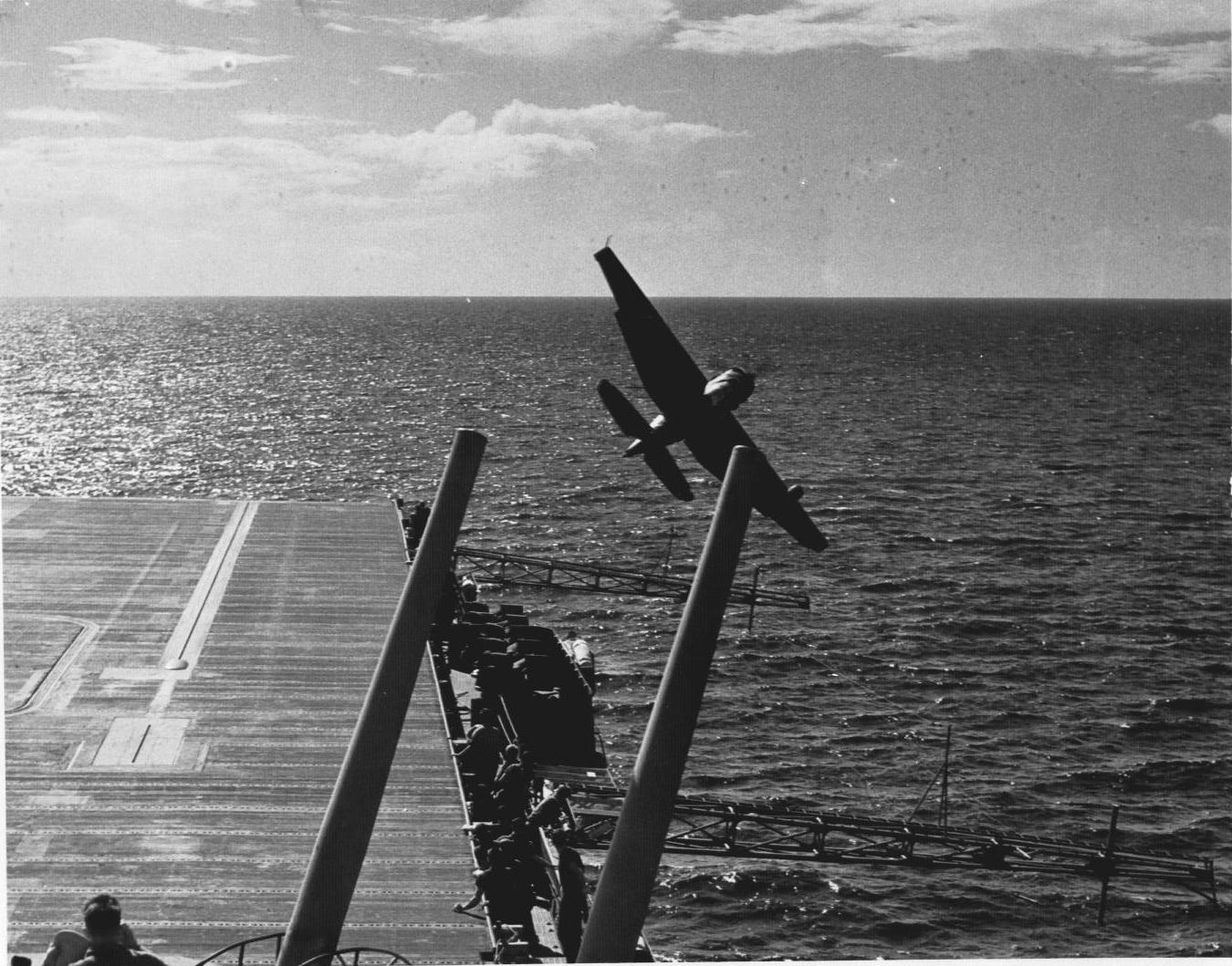 US Navy pilot Lt (jg) C. Clifton Francom unsuccessfully testing TBM Avenger torpedo bomber with experimental wing mounted radome aboard Ticonderoga, 4 Jul 1944, photo 2 of 5