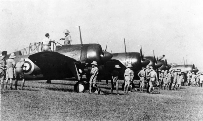 Buffalo Mark I fighters of Nos. 21 and 453 Squadrons RAAF being inspected by RAF personnel, Sembawang airfield, Singapore, 12 Oct 1941