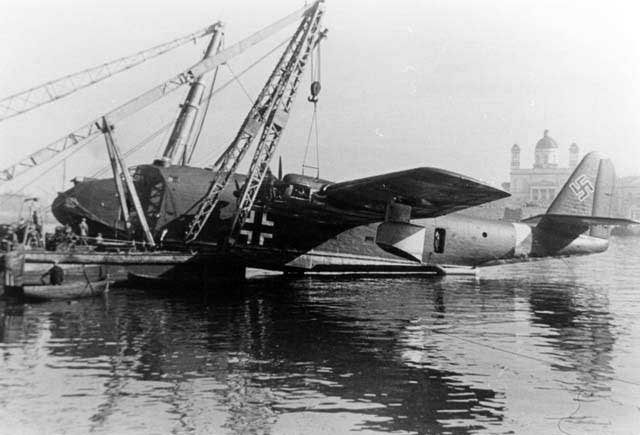 BV 222 Wiking aircraft V2 hanging from a crane while undergoing repair at Piraeus, Greece, 16 Dec 1941. Note the high dome of the Church of St. Nicholas in the background.