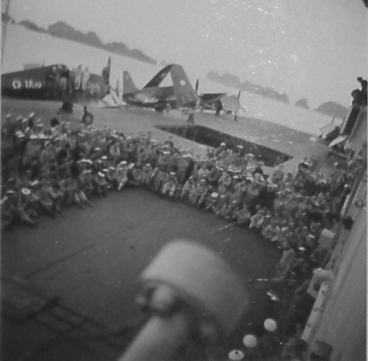 Roland Toutain entertaining French sailors aboard Arromanches, Ha Long Bay, French Indochina, 1952