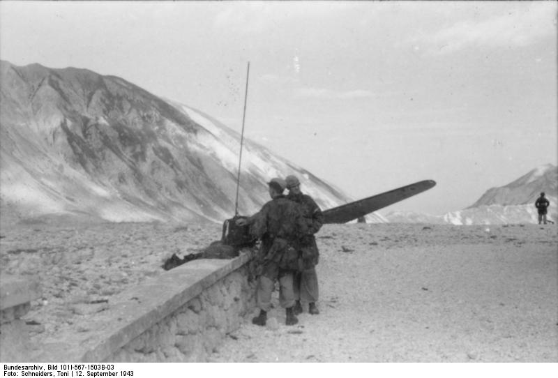 German glider troops operating a radio during Operation Eiche, Gran Sasso, Italy, 12 Sep 1943; note wing of a landed DFS 230 glider in background