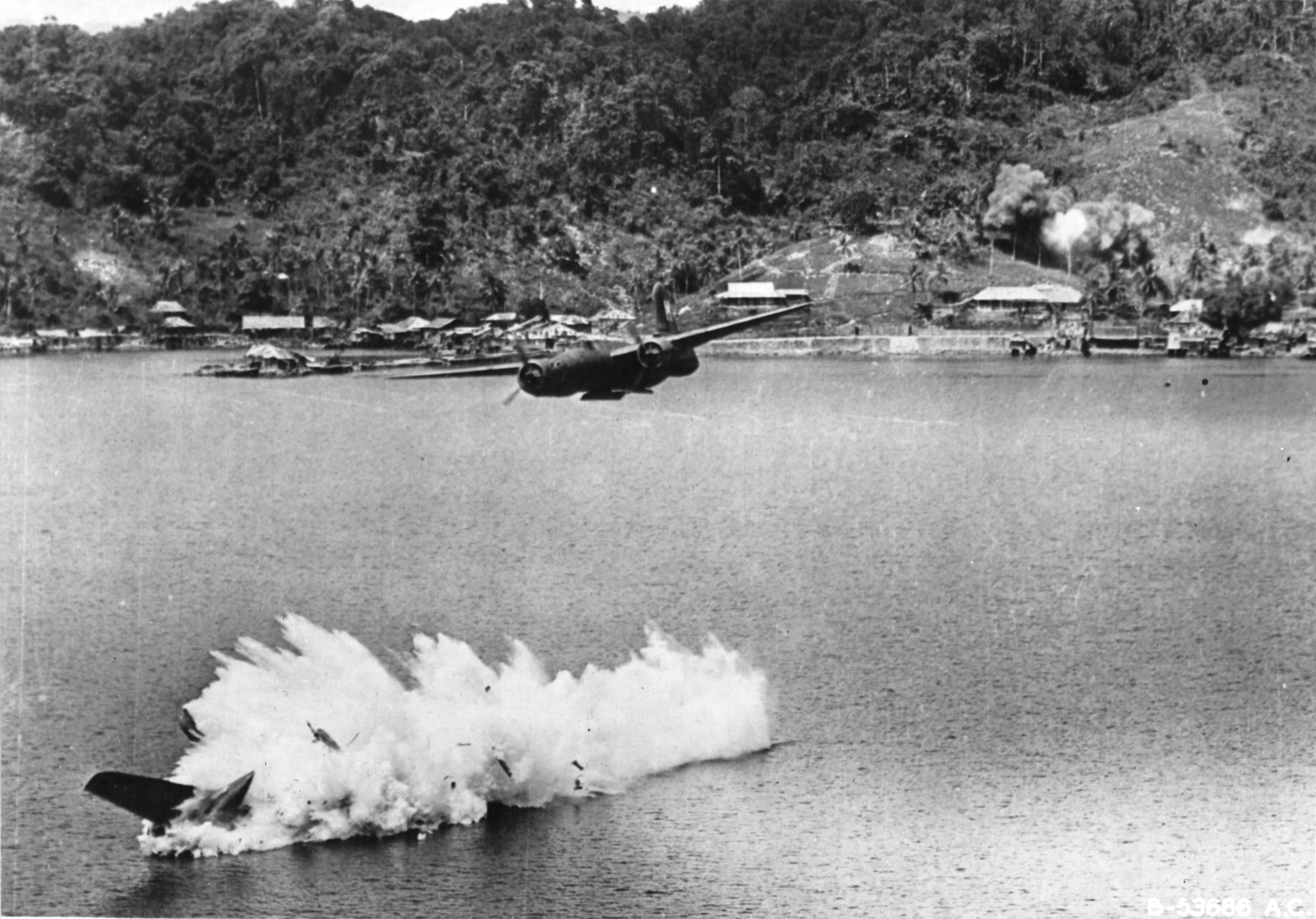 Douglas A-20G Havoc of the 387th Bomb Squadron crashing into the water after being shot down by anti-aircraft fire during an attack on Kokas, western New Guinea, 22 Jul 1944. All crewmembers were killed. Photo 3 of 4.
