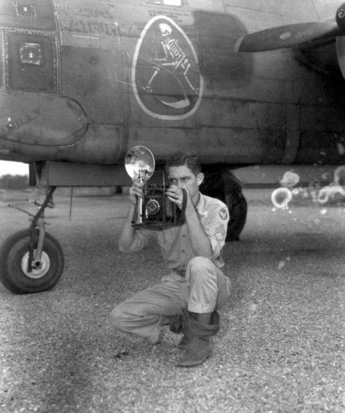 USAAF photographer Jack Heyn posing before an A-20 aircraft, Hollandia, 1944