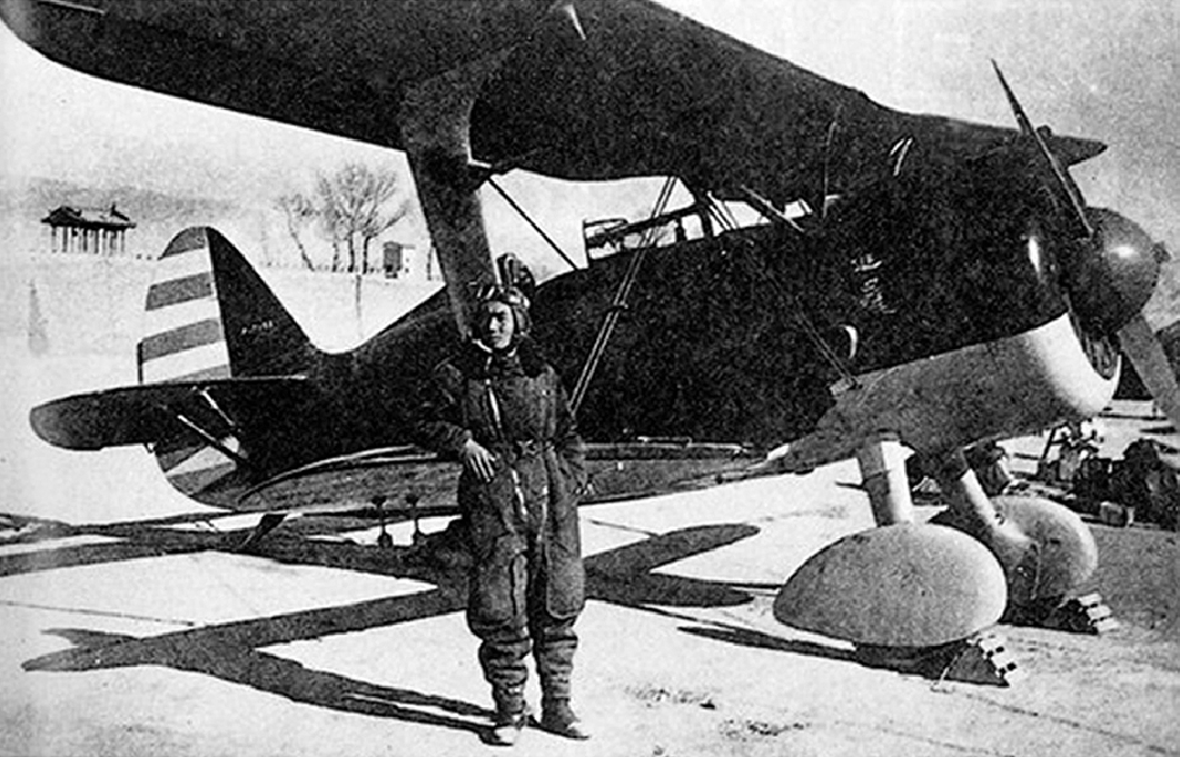 Chinese Air Force pilot Xu Huajiang with an I-15 fighter, date unknown