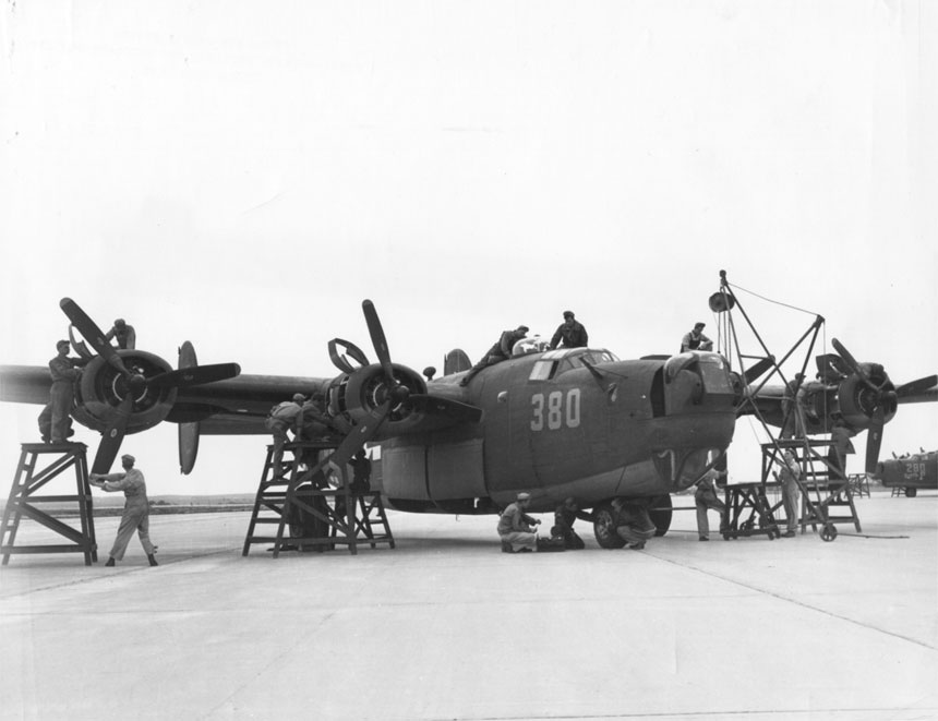 Mechanics at Laredo Army Air Field, Texas, US checked a B-24 bomber before its flight, 8 Feb 1944