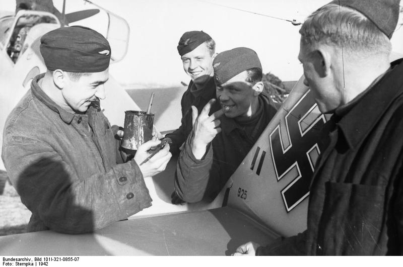 German airmen painting markings on the rudder of a Bf 109 fighter, Russia, 1942, photo 1 of 2