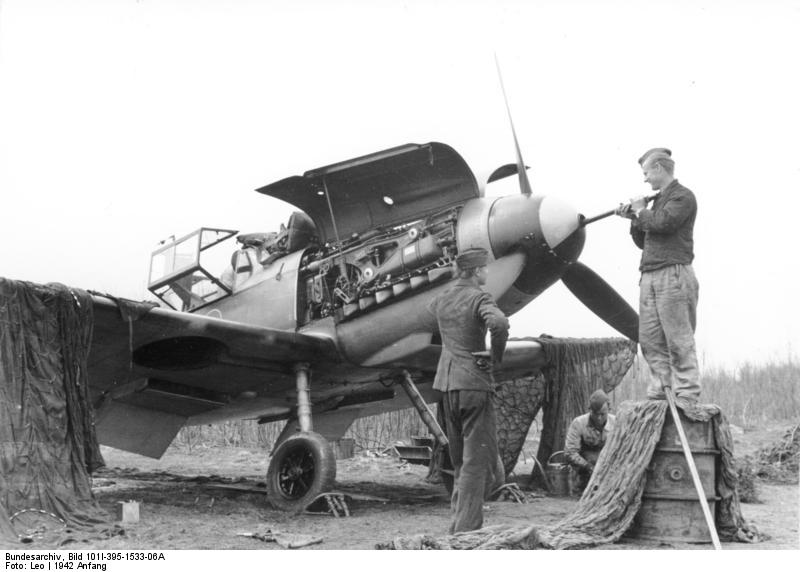 German crew cleaning the 20mm cannon of a Bf 109 fighter, Russia, early 1942