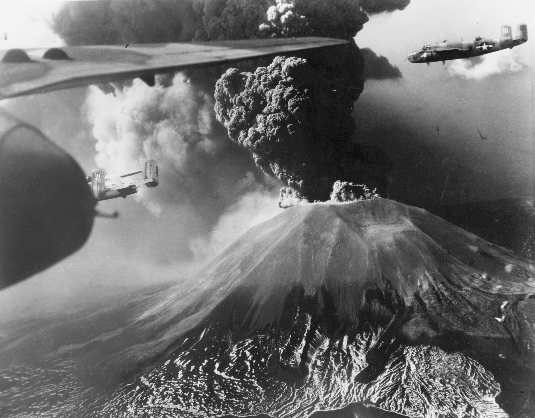 B-25 Mitchell bombers of 321st Bomber Group, US 447th Bomber Squadron flying past Mount Vesuvius, Italy during its eruption of 18-23 Mar 1944