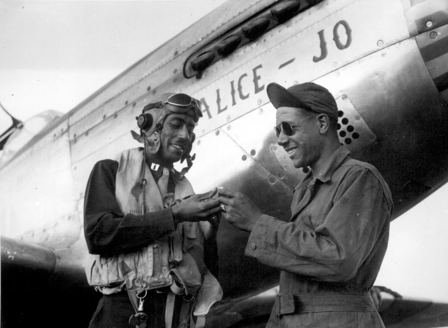 US 15th Air Force African-American pilot Captain Wendell Pruitt leaving his ring with his crew chief Staff Sergeant Samuel Jacobs before leaving on a mission in his P-51 Mustang fighter, Nov 1944