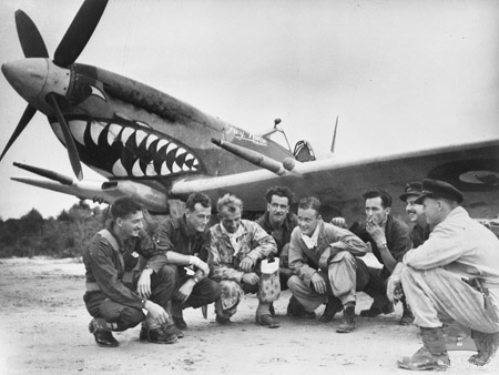 Australian pilots of the No. 457 Squadron 'Grey Nurse' RAAF in the Brunei Bay area, Borneo, 19 Oct 1945; note Spitfire fighter in background