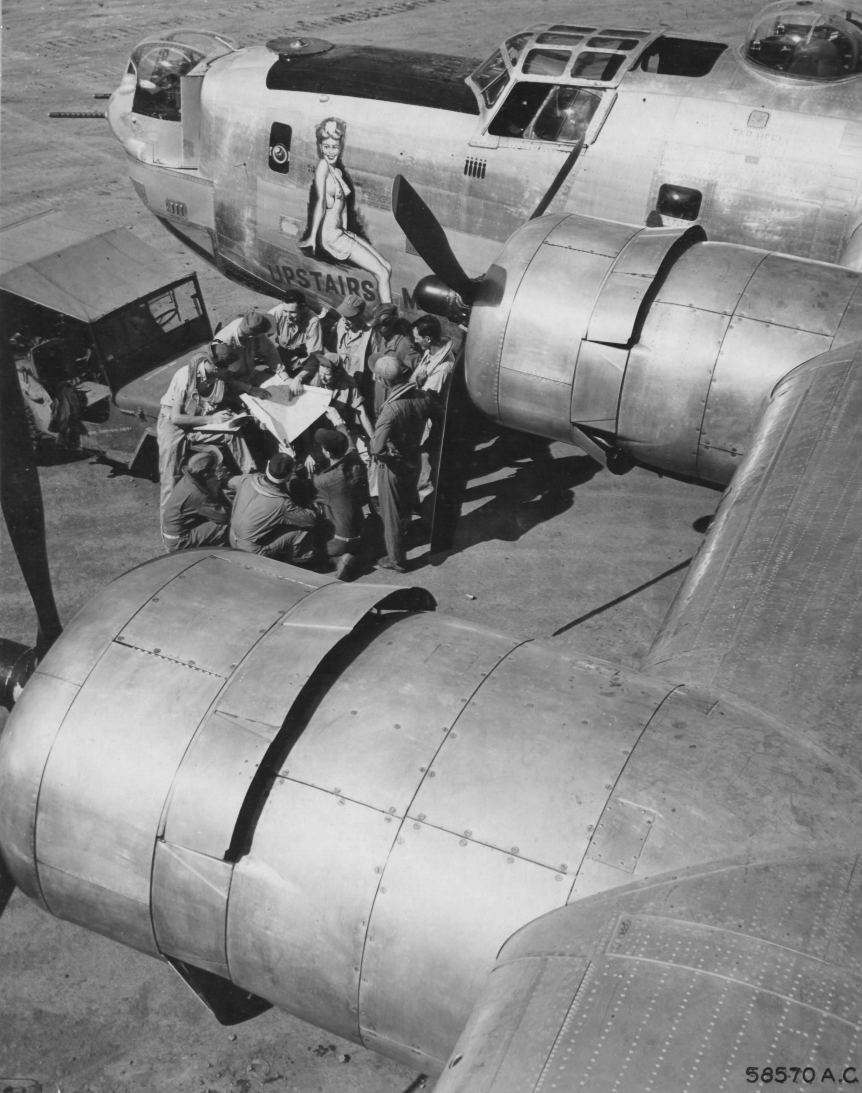 Crew of B-24J Liberator bomber 'Upstairs Maid' being briefed before a mission, Saipan, Mariana Islands, 1945