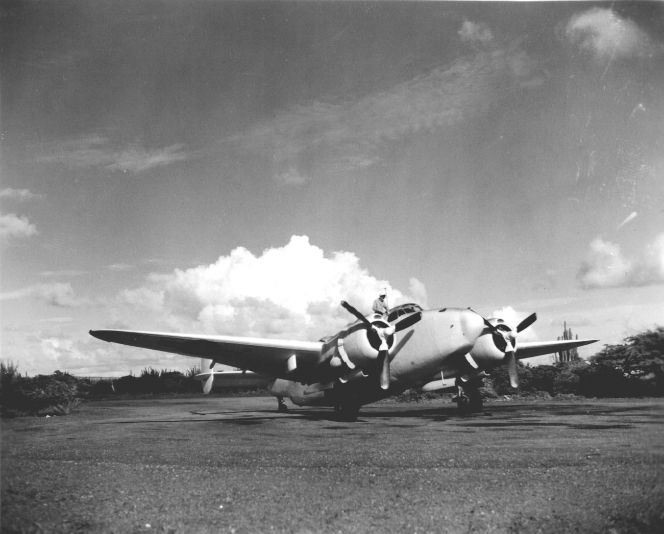 US Navy sailor performing routine maintenance on a PV-1 Ventura aircraft of squadron VB-141 at Hato Field, Curaçao, Netherlands West Indies, Nov 1943