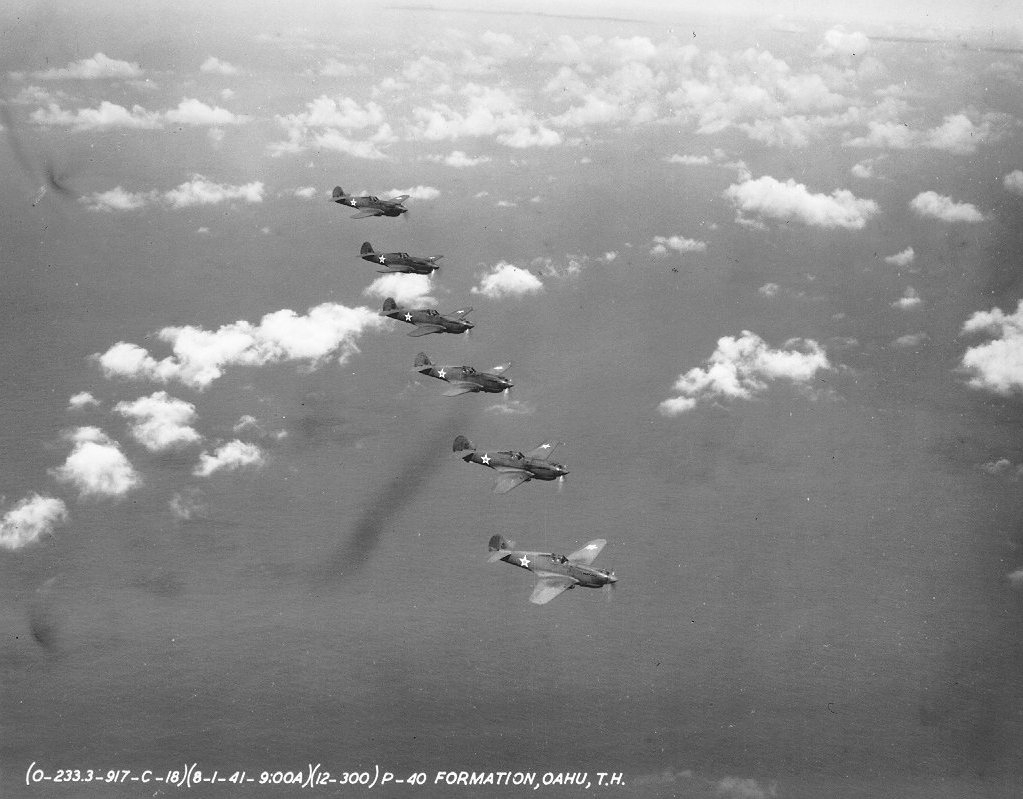 Six P-40 Warhawk fighters based at Hickam Field in flight over Oahu, US Territory of Hawaii, 1 Aug 1941, photo 2 of 2