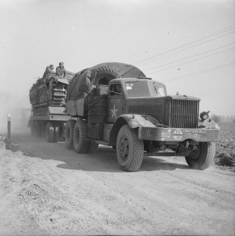 British Diamond T Model 980 tractor towing a trailer loaded with a Churchill tank during preparations for crossing the Rhine River into Germany, 23 Mar 1945