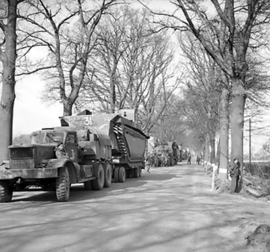 Buffalo tracked landing vehicles of UK 4th Royal Tank Regiment being transported forward in preparation for crossing the Rhine River into Germany, 21 Mar 1945