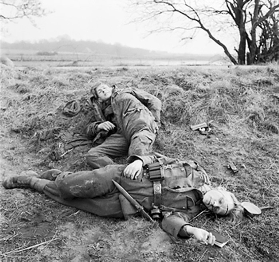 Two young German soldiers, one injured, the other dead, east of the Rhine River, Germany, late Mar 1945