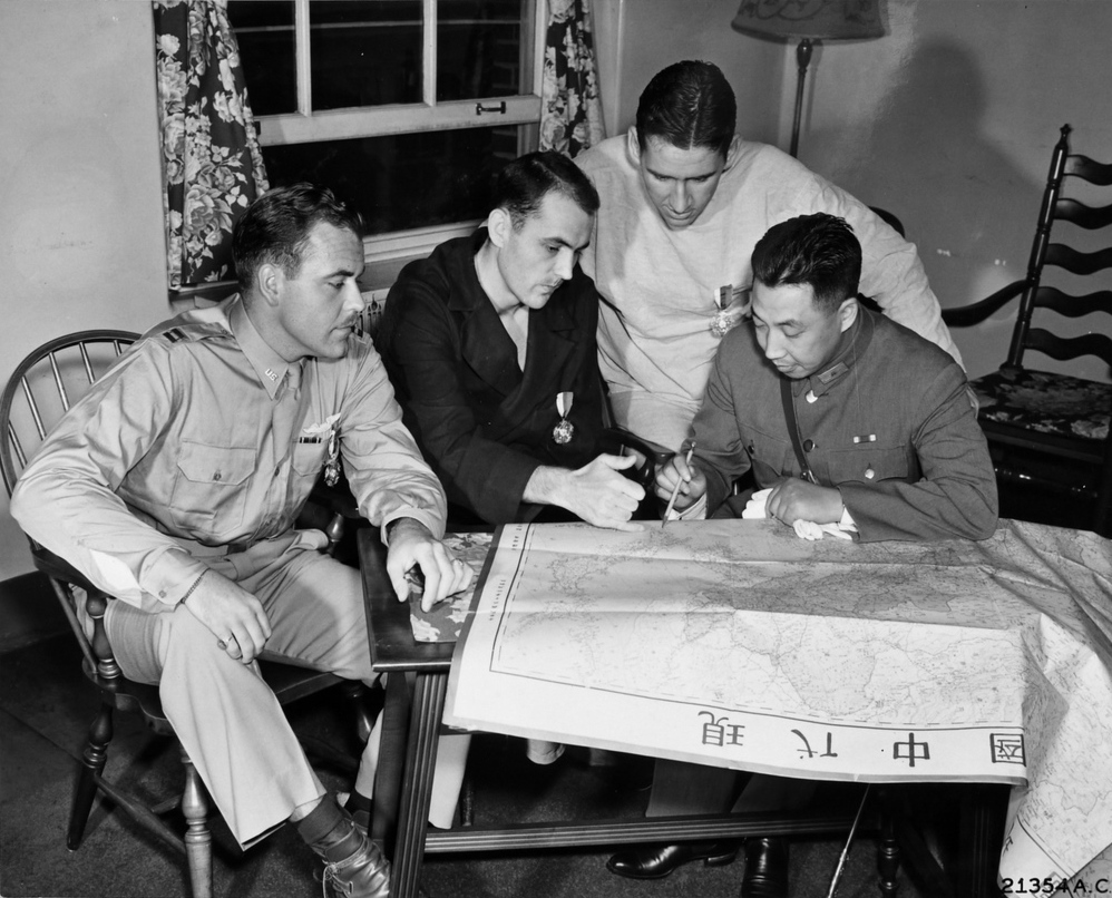 Chinese Major General Zhu Shiming studying a map with Doolittle Raiders Harold Watson, Charles McClure, and Ted Lawson, Walter Reed Hospital, Washington DC, United States, 25 Jul 1942