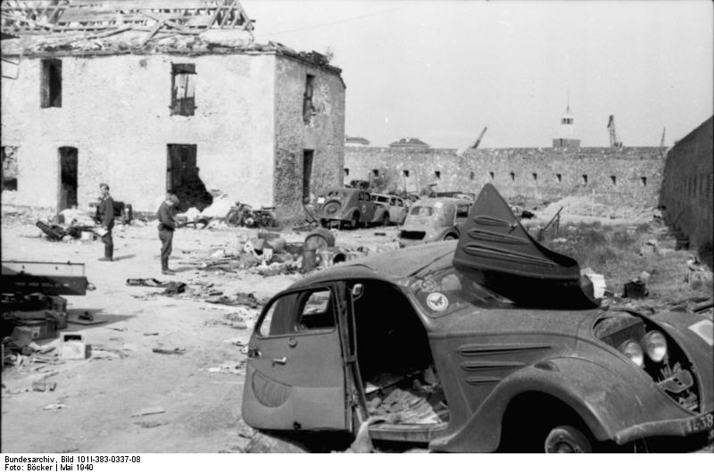 Destroyed cars and buildings at Calais, France, May 1940