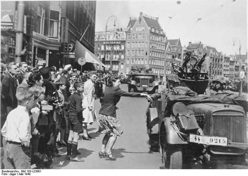 A Dutch woman welcoming German SS troops arriving in Amsterdam, the Netherlands, May 1940