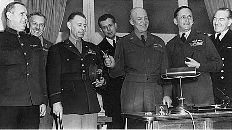 Generals Susloparov, Morgan, Smith, Eisenhower, Air Chief Marshal Tedder after signing of German surrender documents, Rheims, France, 7 May 1945, photo 1 of 3; note Eisenhower holding pens used