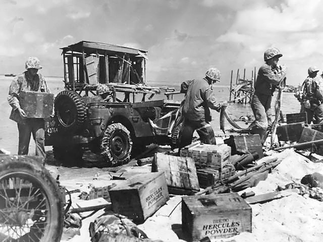 US Marines unloading ammunition from a jeep which had just been driven directly off of a landing barge, Tarawa, Gilbert Islands, Nov 1943