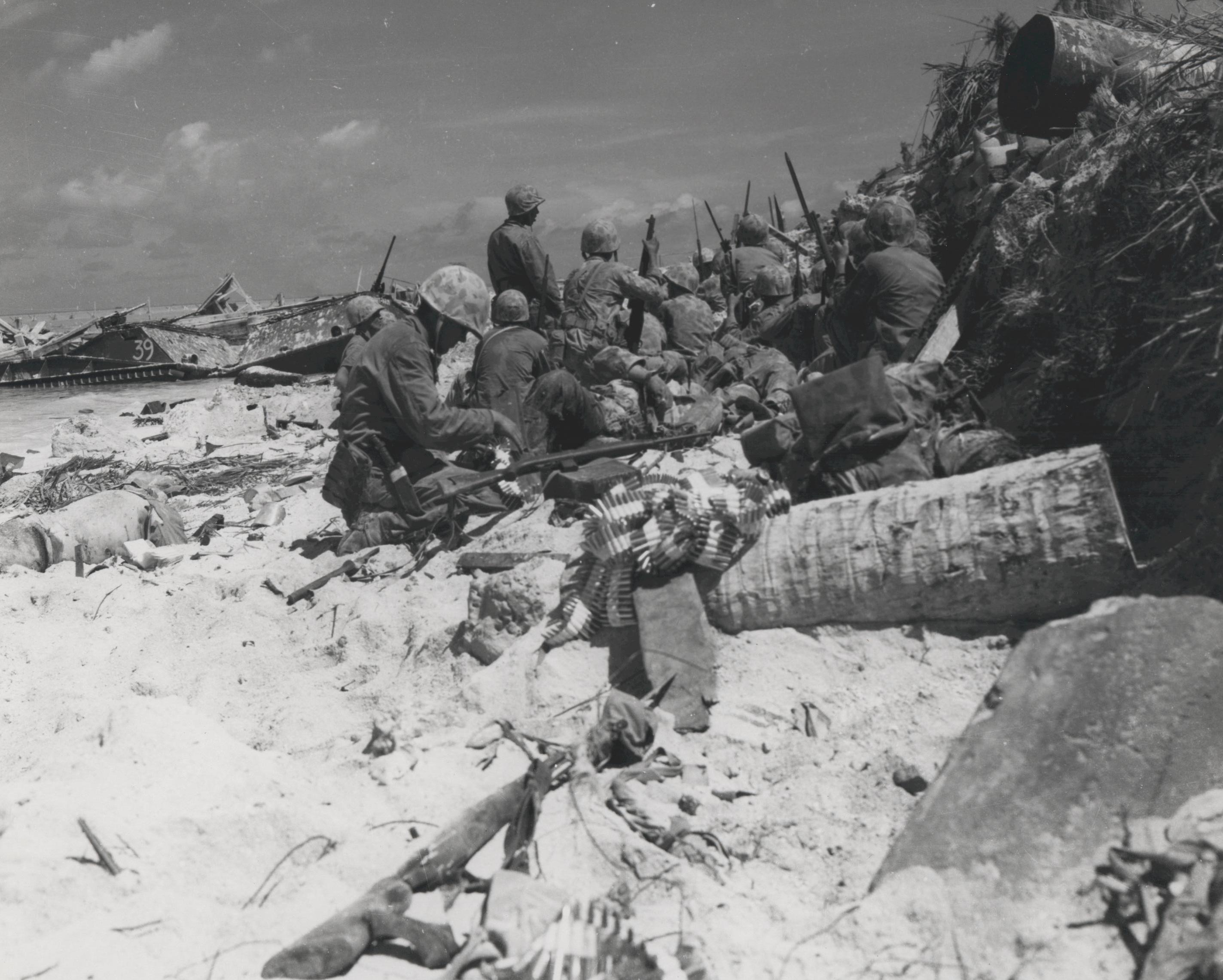 US Marines taking cover behind a barricade on 'Red Beach 3', Betio, Tarawa Atoll, Gilbert Islands, 20 Nov 1943, photo 2 of 2