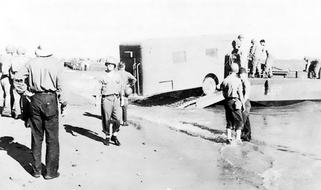 Men and supplies of the 132d Regimental Combat Team of the US Army Americal Division, Kikum, Guadalcanal, Solomon Islands, 8 Dec 1942