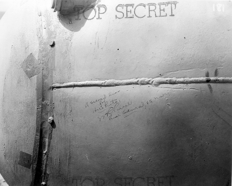 'A second kiss for Hirohito' message on the side of 'Fat Man' bomb by Rear Admiral W. R. Purnell while the bomb was in Tinian, Mariana Islands, Aug 1945