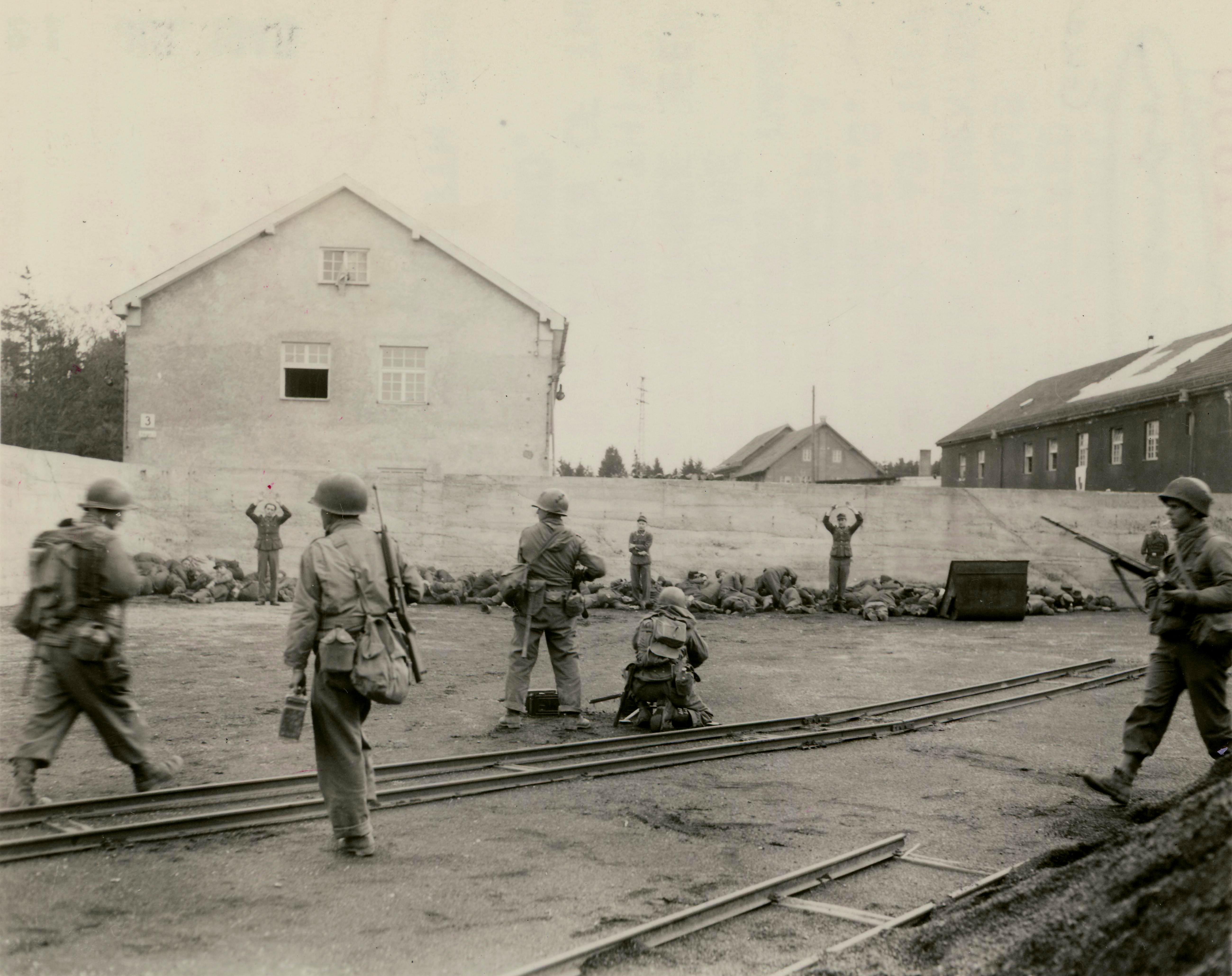 US Army troops executing German SS guards at Dachau Concentration Camp, Germany, 29 Apr 1945